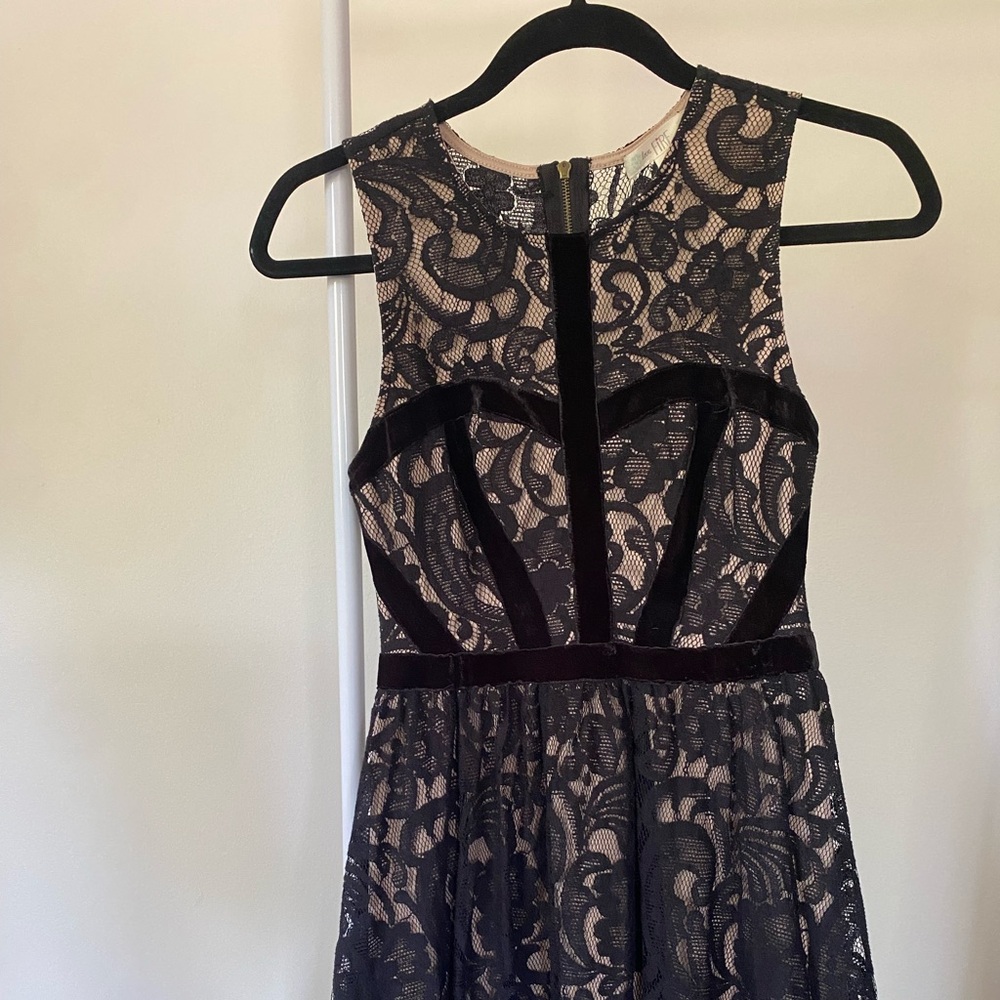 Black Lace detail mini dress 
Zipper back
Size small
Minor wear and tear